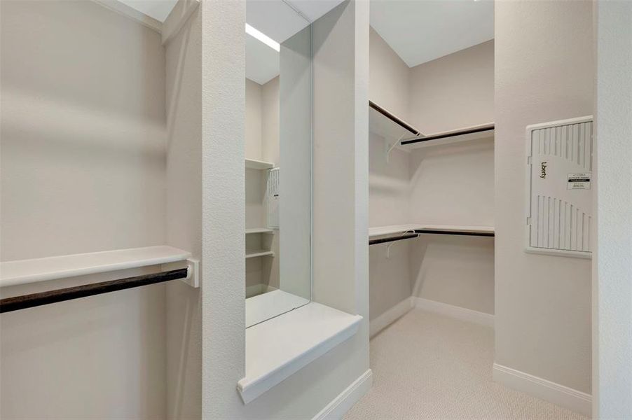 Walk in closet with light colored carpet Walk in closet with light colored carpet