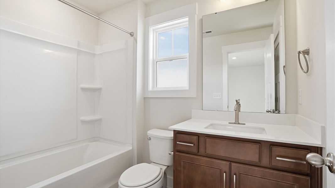 Elegant bath retreat with designer finishes and a clean, timeless aesthetic by DRB Homes Elegant bath retreat with designer finishes and a clean, timeless aesthetic by DRB Homes