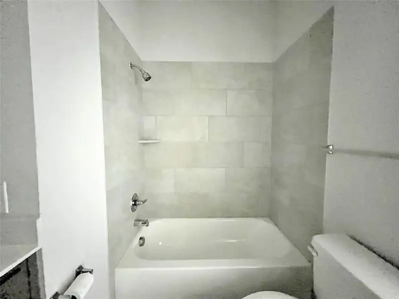 Full bathroom with washtub / shower combination and toilet Full bathroom with washtub / shower combination and toilet