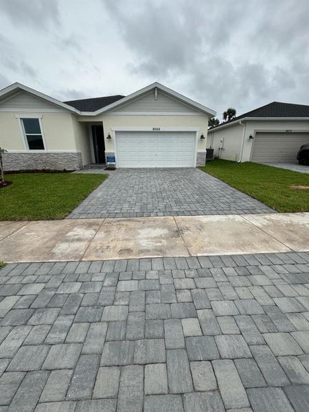 Front exterior of a new home in Azalea, Port St. Lucie, FL, highlighting curb appeal (Image 13).