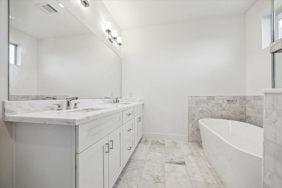 Primary Bathroom * Double Sinks * Modern Fixtures and Lighting.