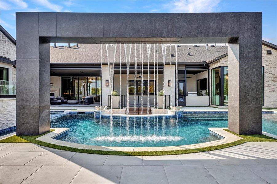 View of swimming pool featuring a patio area and a pool with connected hot tub View of swimming pool featuring a patio area and a pool with connected hot tub