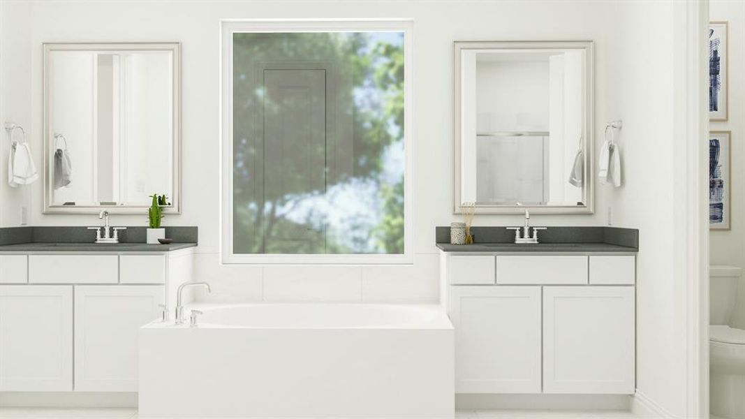 Bathroom with a tub to relax in, toilet, and dual bowl vanity