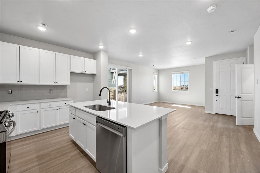 A kitchen with white cabinets.