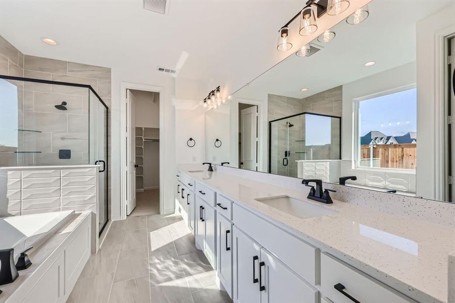 Bathroom with vanity and a shower with door