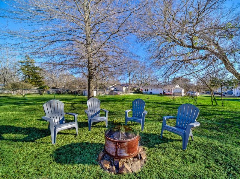 View of yard with an outdoor fire pit