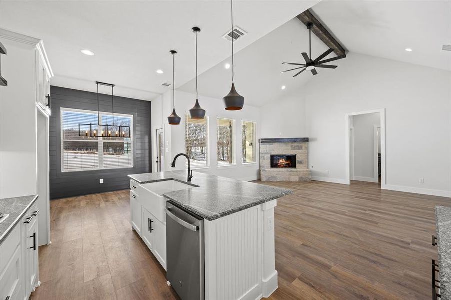 Kitchen featuring white cabinets, dark wood finished floors, open floor plan, and dishwasher