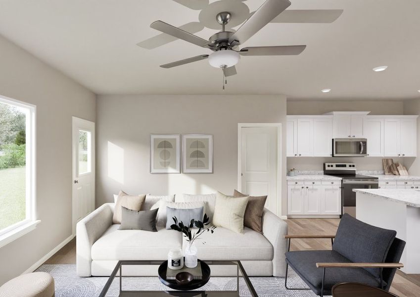 A cozy living room with a beige sofa adorned with cushions, a glass coffee table, and a ceiling fan. Bright window light, modern kitchen in background. A cozy living room with a beige sofa adorned with cushions, a glass coffee table, and a ceiling fan. Bright window light, modern kitchen in background.