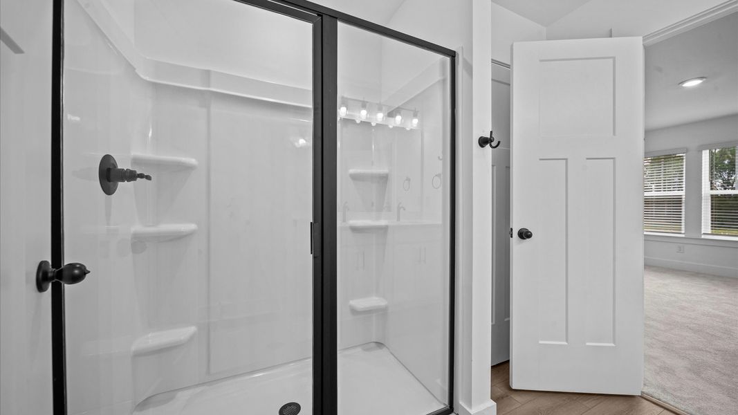 Exceptional en-suite with dual vanity and glass-enclosed walk-in shower for superior everyday comfort