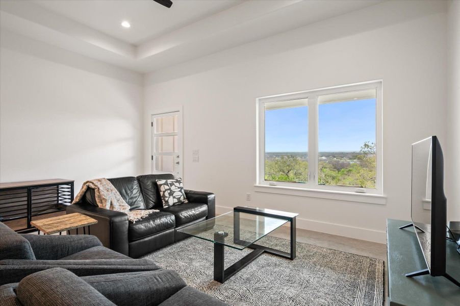 Living area with picture framed windows that fully crank upon to capture the breeze.
