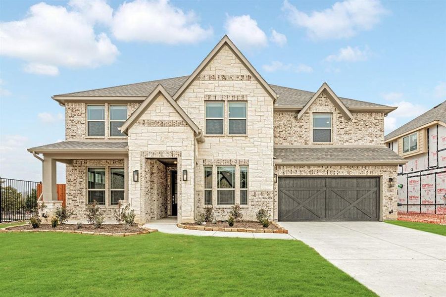 French country home featuring a shingled roof, concrete driveway, an attached garage, and stone siding