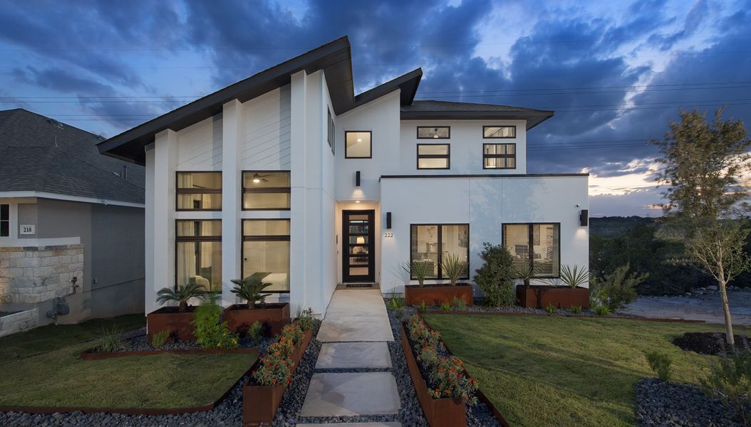 Representative exterior photo of a completed home built from the 2458E by Perry Homes in Veramendi, New Braunfels, TX (Image 11).