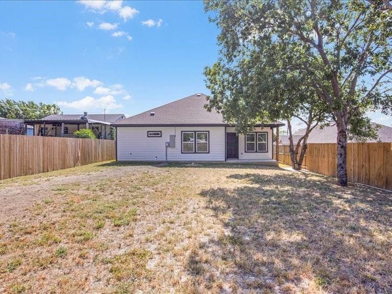 Rear view of property featuring a lawn