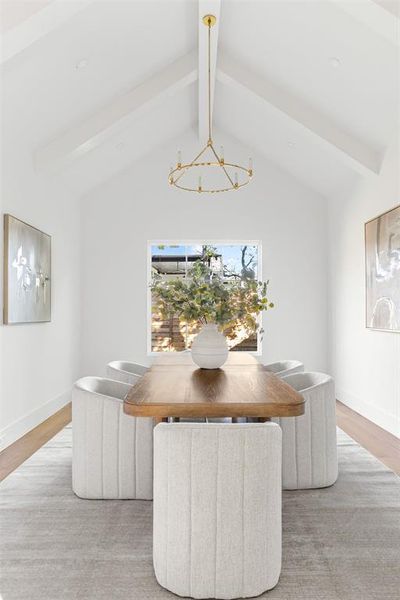 Dining room with light wood-type flooring and a chandelier Dining room with light wood-type flooring and a chandelier