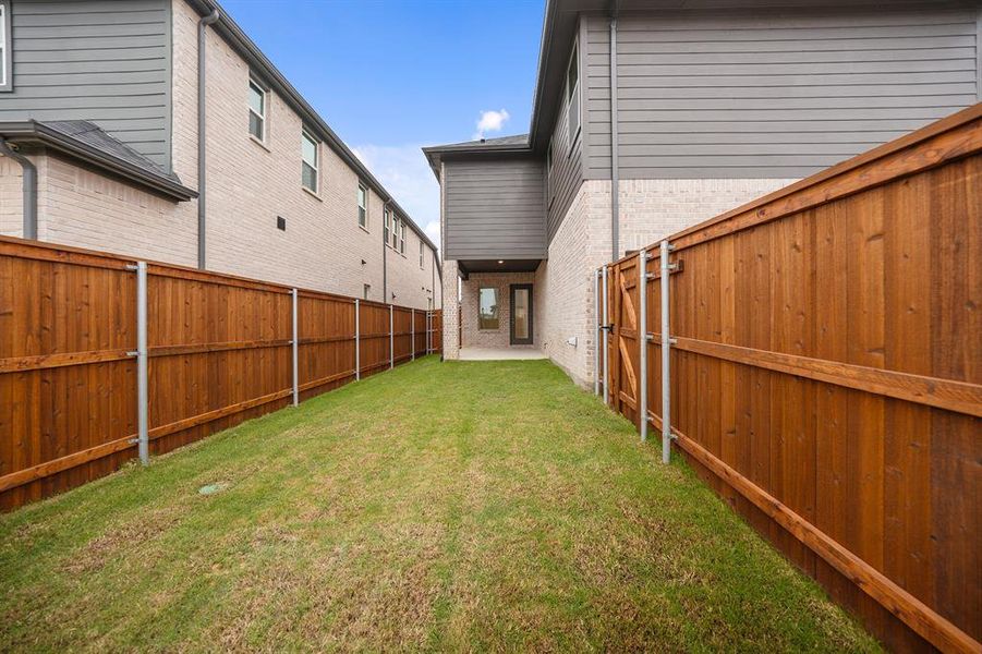 Fenced backyard with a patio