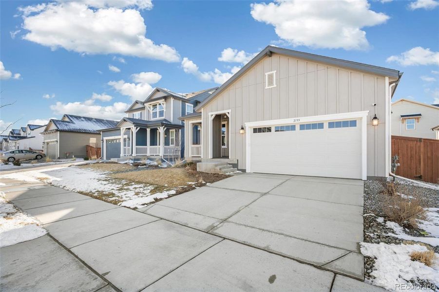 Front exterior of a new home in Farmlore, Brighton, CO, highlighting curb appeal (Image 27).