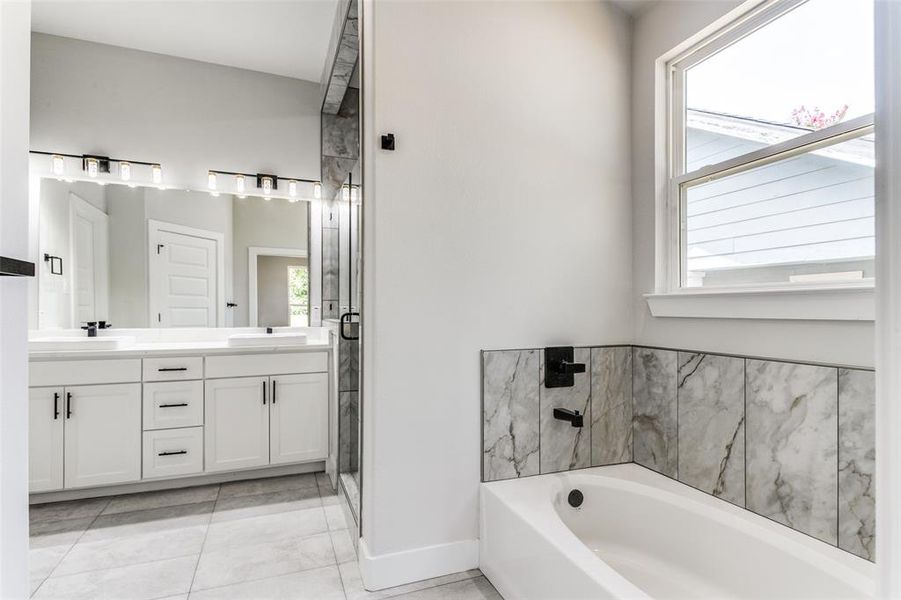 Bathroom featuring double vanity and tile patterned floors