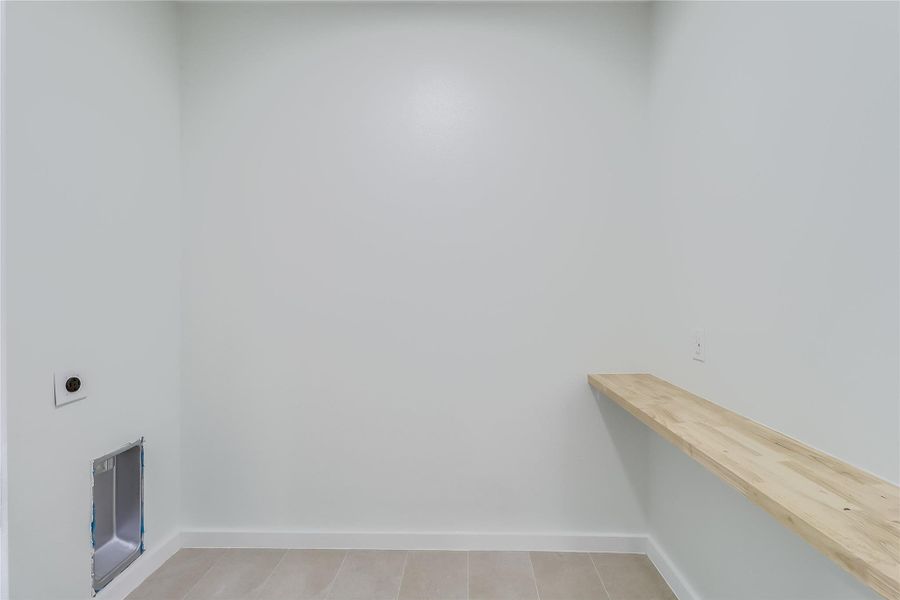 Laundry room featuring hookup for an electric dryer, laundry area, and baseboards