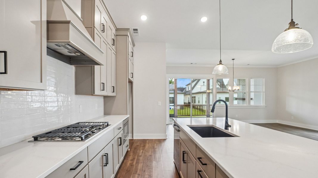 Kitchen with quartz countertops and gas range