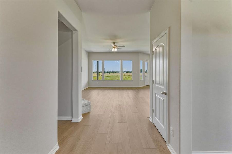 Open concept living area with wood-finish flooring and abundant natural light