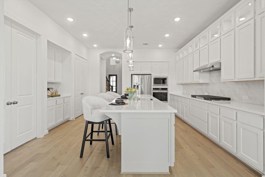 You’ll love the details of this kitchen! With quartz countertops, elegant tiled backsplash, neutral flooring, and gas range, it’s perfect for everyday life or entertaining family and friends.