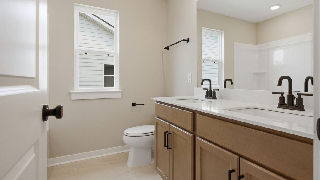 Bathroom with dual vanity and window Bathroom with dual vanity and window