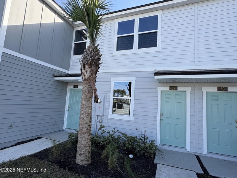 Exterior details and patio area of a home in Cordera Townhomes, St. Augustine (Image 2).