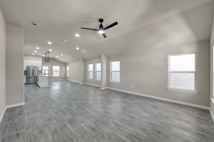 Designed for entertaining, this massive open-concept living space is flooded with natural light and seamlessly connects the great room to the heart of the home.