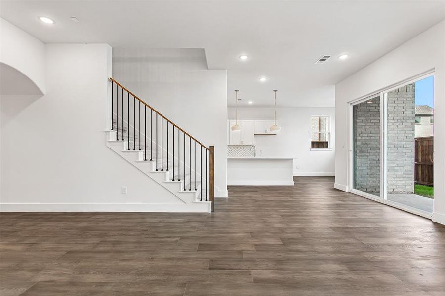 Unfurnished living room featuring dark hardwood / wood-style flooring