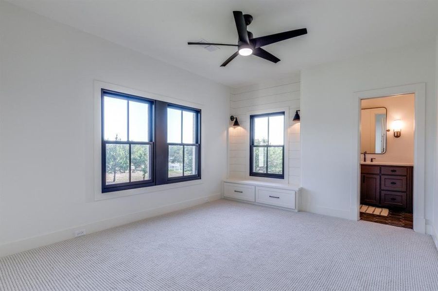 Unfurnished bedroom featuring light carpet, connected bathroom, and a ceiling fan Unfurnished bedroom featuring light carpet, connected bathroom, and a ceiling fan