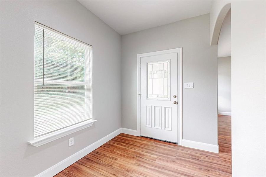 Entrance foyer featuring light hardwood / wood-style floors