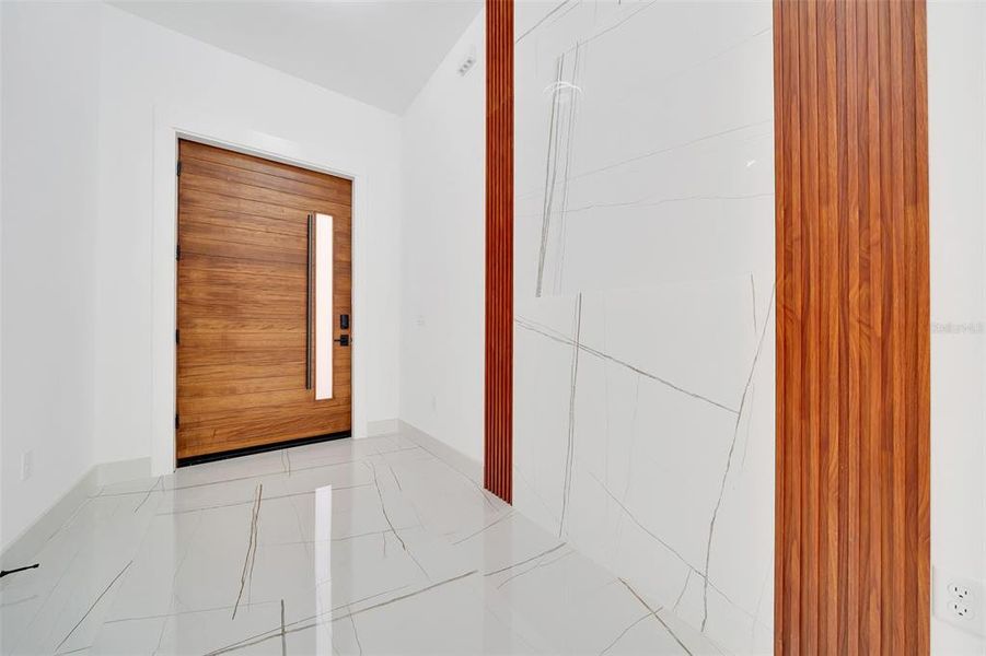 FOYER WITH WATERFALL OF TILE AND MAHOGANY TRIM ACOUSTIC PANELS