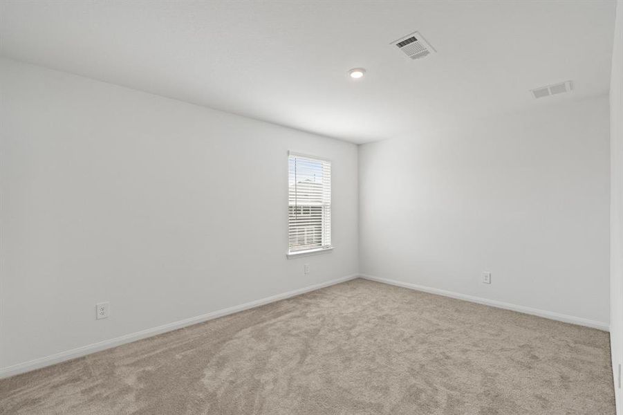 Serene Secondary bedroom on second featuring plush carpet, neutral finishes and easy access to the Flex Space and bathroom.