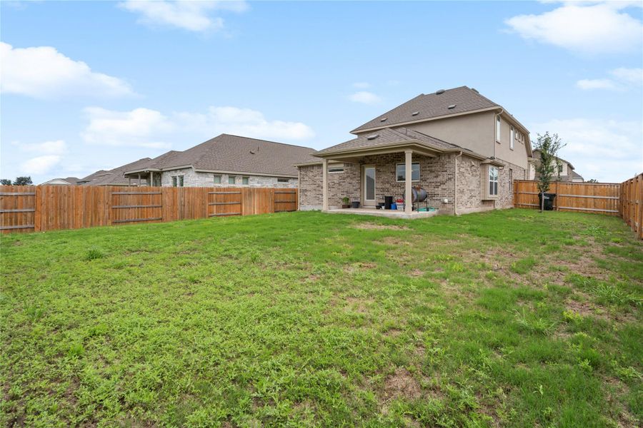 Back of house featuring a patio and brick siding Back of house featuring a patio and brick siding