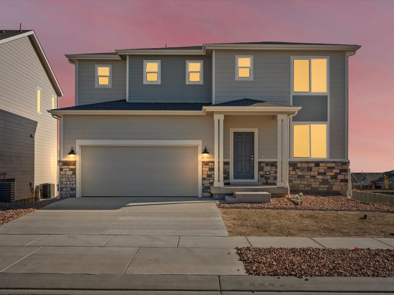 Front exterior of a new home in Meridian Ranch, Peyton, CO, highlighting curb appeal (Image 1). Front exterior of a new home in Meridian Ranch, Peyton, CO, highlighting curb appeal (Image 1).