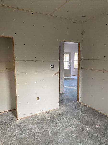 Unfurnished room with unfinished concrete floors