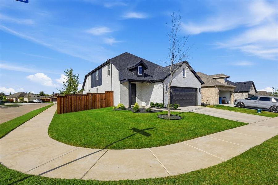 Front exterior of a new home in , Rhome, TX, highlighting curb appeal (Image 22). Front exterior of a new home in , Rhome, TX, highlighting curb appeal (Image 22).