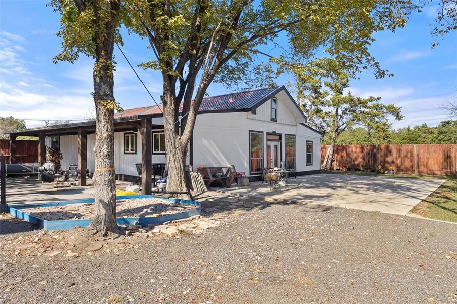 Back of property featuring a patio, french doors, and a metal roof Back of property featuring a patio, french doors, and a metal roof
