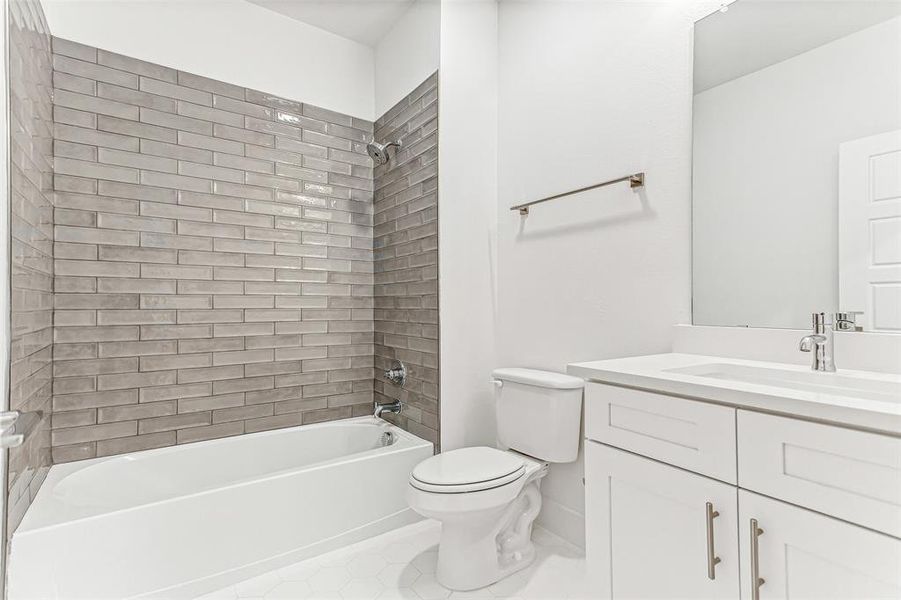 Full bathroom featuring bathing tub / shower combination, vanity, and tile patterned flooring