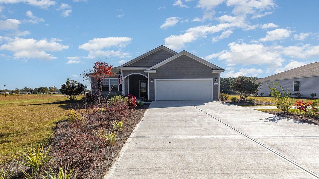 Front exterior of a new home in Heron Pointe, Myrtle Beach, SC, highlighting curb appeal (Image 1). Front exterior of a new home in Heron Pointe, Myrtle Beach, SC, highlighting curb appeal (Image 1).