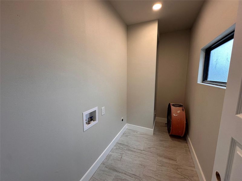 Laundry area featuring washer hookup, hookup for an electric dryer, recessed lighting, and light marble finish floors