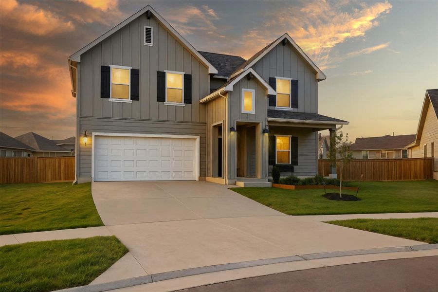 View of front facade featuring board and batten siding, covered porch, an attached garage, and driveway