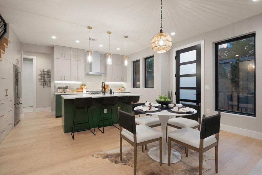 Dining area featuring light wood-style flooring and recessed lighting
