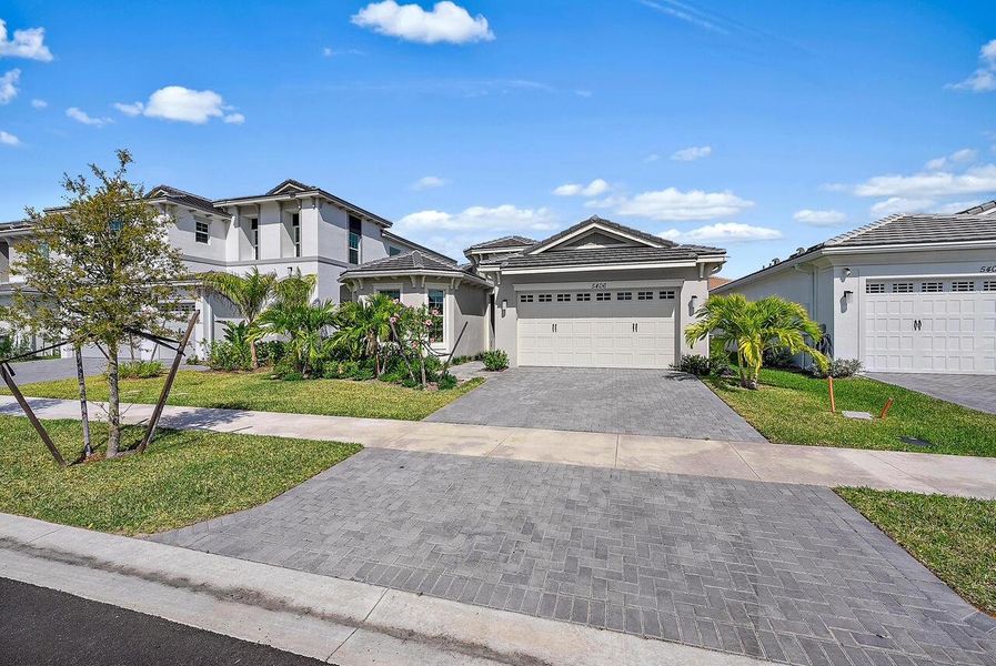 Front exterior of a new home in Westlake, Westlake, FL, highlighting curb appeal (Image 1).