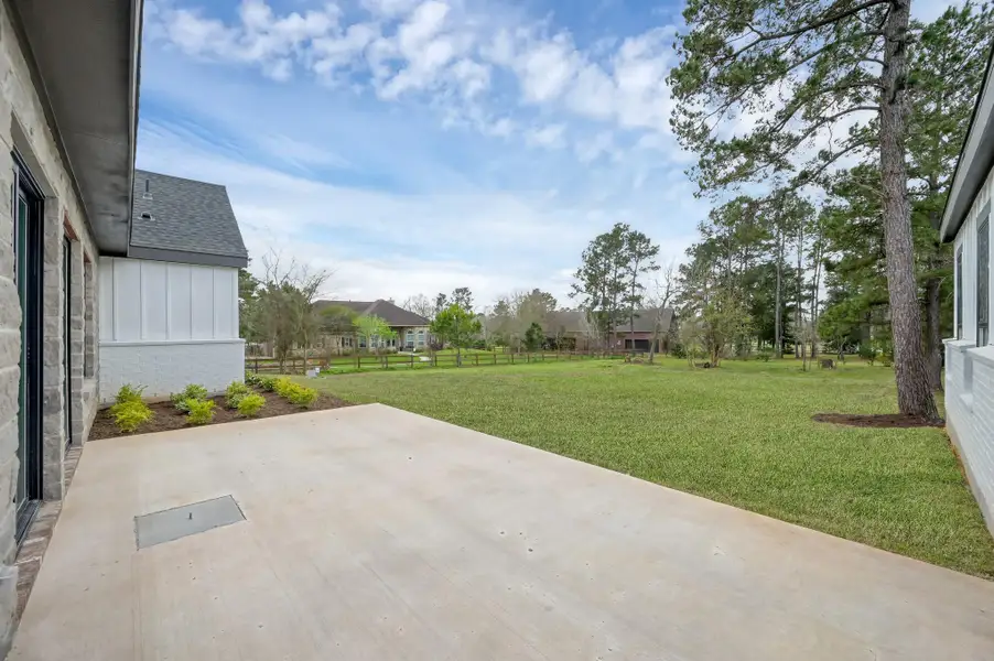 Covered back patio offers the perfect setting for outdoor dining and relaxing while overlooking the expansive backyard.