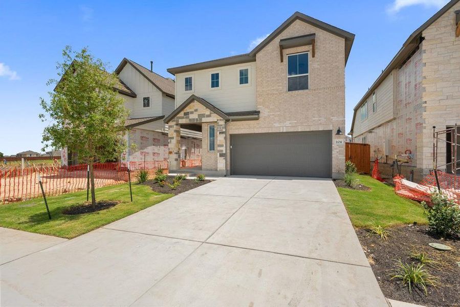 Front exterior of a new home in Lariat, Liberty Hill, TX, highlighting curb appeal (Image 1). Front exterior of a new home in Lariat, Liberty Hill, TX, highlighting curb appeal (Image 1).