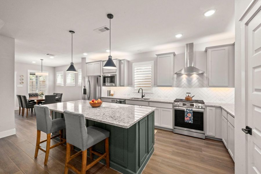 Rich finishes paired with recessed and under-cabinet lighting create a warm, inviting kitchen. Rich finishes paired with recessed and under-cabinet lighting create a warm, inviting kitchen.