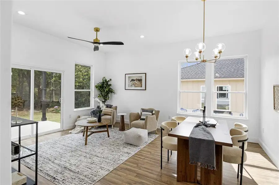 Dining space featuring light wood-style floors, recessed lighting, ceiling fan, and a chandelier Dining space featuring light wood-style floors, recessed lighting, ceiling fan, and a chandelier