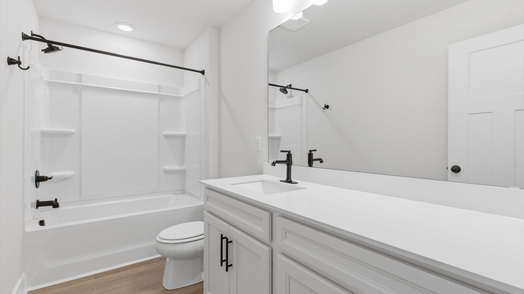 Stylish guest bathroom with superior design and thoughtful storage solutions located at Pelham Crossing