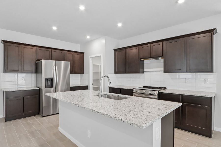 A kitchen with black cabinets.